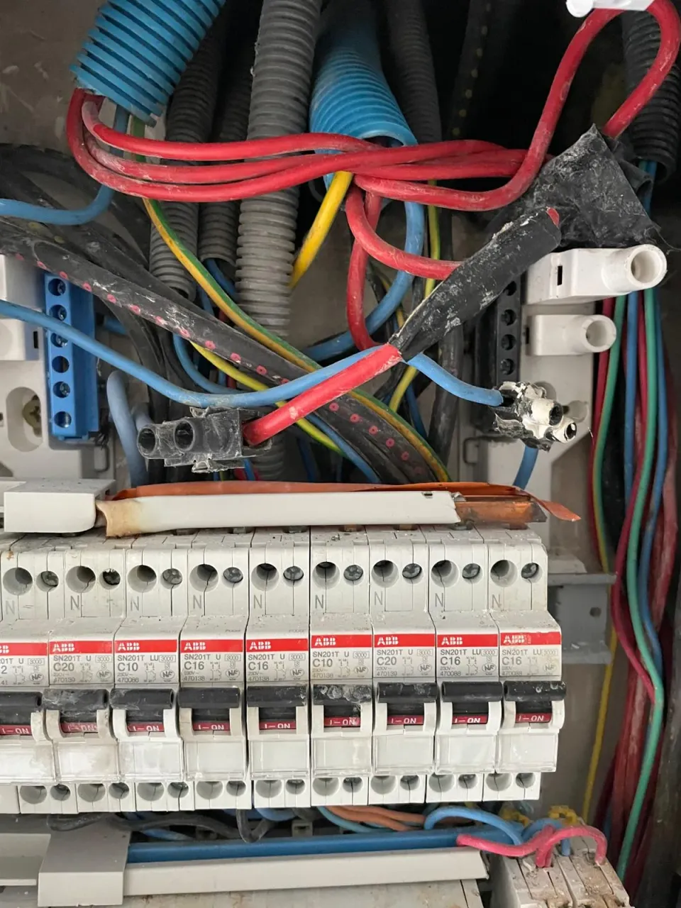 Tableau électrique endommagé après un début d'incendie, avant remise en sécurité après un court-circuit